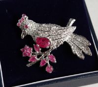 A SILVER RUBY SET BIRD BROOCH