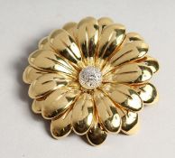 A SUPERB 18CT GOLD FLOWER BROOCH 7cm diameter, with P set diamond centre. 48gms