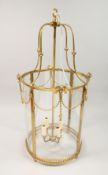 A GEORGIAN STYLE BRASS CIRCULAR HALL LANTERN 32ins high.