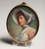 AN OVAL PORTRAIT MINIATURE OF A LADY wearing a bonnet 3ins x 2.5ins