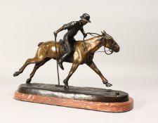 A CONTEMPORARY BRONZE MODEL OF A POLO PLAYER IN ACTION, mounted on a rouge marble base, Signed 15ins