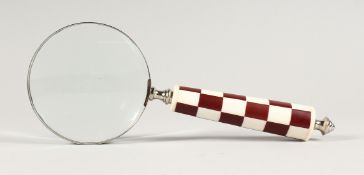 A MAGNIFYING GLASS WITH CHEQUERED HANDLE.