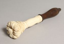 A 19TH CENTURY CARVED IVORY AND TURNED WOOD TIPSTAFF, the top as a crown 7.5ins long.