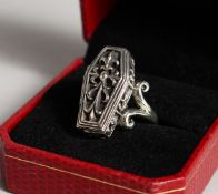 A SILVER COFFIN SHAPED RING