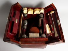 A GENTLEMAN'S CROCODILE TRAVELLING CASE with silver and ivory fittings, seven silver top bottles,