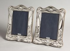 A PAIR OF SILVER PHOTOGRAPHS FRAMES, in Art Nouveau style 8ins x 6.25ins