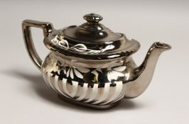 A SILVER LUSTRE DECORATED POTTERY TEA POT 10ins long