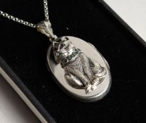 A SILVER CAT LOCKET set with ruby and emeralds