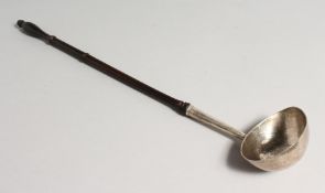 A GEORGE II TODY LADEL with turned wood handle 15ins long London 1743