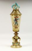 A GERMAN GREEN TINTED VASE AND COVER painted with a man carrying a sword. 16ins high.