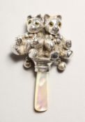 A SILVER DOUBLE TEDDY MOTHER OF PEARL RATTLE.