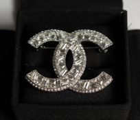 A CHANEL REPLICA DOUBLE 'C' BROOCH in a box