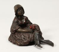 A SMALL EROTIC BRONZE FIGURE OF A SEATED GIRL, holding a posy of flowers 3.5ins high.