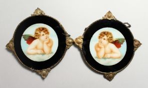 A PAIR OF CIRCULAR PLAQUES OF CUPIDS 6ins diameter.