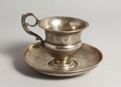 A FRENCH SILVER CUP AND SAUCER, with engraved decoration Saucer 6ins diameter.