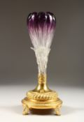 A CONTINENTAL RUBY TINTED GLASS VASE with gilded metal base 12ins high.