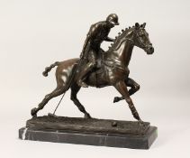 A CONTEMPORARY BRONZE MODEL OF A POLO PLAYER IN ACTION, mounted on a rectangular marble base, with