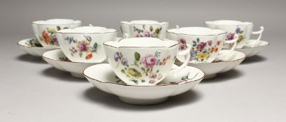 A SET OF SIX 18TH CENTURY MEISSEN PORCELAIN SHAPED CUPS AND SAUCERS,painted with flowers and