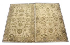 A PAIR OF INDIAN CARPETS, 20TH CENTURY, beige ground with stylised leaf and flowers decoration 8ft