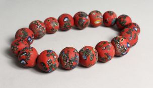 POSSIBLY ROMAN, A SEVENTEEN RED MILLIFIORE GLASS NECKLACE