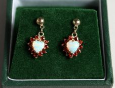 A PAIR OF 9CT GOLD OPAL AND GARNET HEART SHAPED EARRINGS
