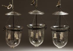 A SET OF THREE ETCHED GLASS AND METAL THREE LIGHT HANGING LANTERNS 20ins high.