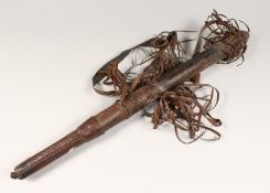 AN AFRICAN LEATHER QUIVER, containing ten steel tipped arrows 30ins long.