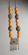 AN ISLAMIC SILVER AMBER TYPE NECKLACE and small box.