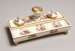 A SPODE PORCELAIN DESK STAND, with candlestick, inkwell and pounce pot, painted with pink roses
