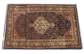 A GOOD PERSIAN RUG, 20TH CENTURY, blue ground, the central panel with stylised boteh design. 6ft