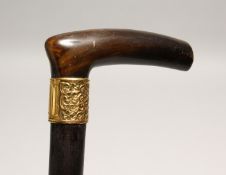 A RHINO HANDLE VICTORIAN WALKING STICK with gilt band 2ft 11ins long.