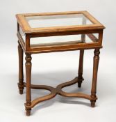 A MAHOGNAY STAINED BIJOUTERIE TABLE, on turned legs united by an 'X' shape stretcher. 2ft wide x 1ft