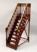 A GOOD MAHOGANY AND BRASS MODEL OF A STAIRCASE, with nine treads, platform top, brass mounted hand
