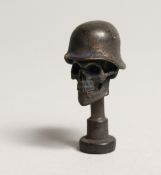 A FIRST WORLD WAR BRASS REPLICA SKULL PIPE TAMPLER 1.75ins long.