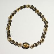 A SUPERB 18CT GOLD AND YELLOW SAPPHIRE NECKLACE BY FARRONE, Circa 1980, set with gun metal.