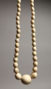 A GOOD GRADUATED IVORY BEAD NECKLACE on one hundred beads 29ins long