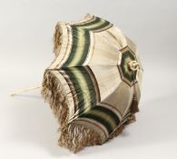 A LATE 19TH CENTURY CHILD'S PARASOL, with carved ivory folding handle 27ins long