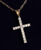 A 9CT GOLD DIAMOND CRUCIFIX ON A CHAIN.