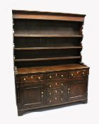 A GOOD 18TH CENTURY NORTH COUNTY OAK WELSH DRESSER the top with three shelves and hooks, the base