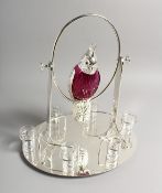 AN UNUSUAL LIQUEUR SET, the decanter modelled as a parrot on a swing, with six shot glasses to the