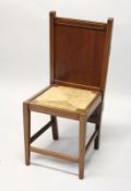 AN UNUSUAL EDWARDIAN MAHOGANY COMBINATION CHAIR/TROUSER PRESS, with panelled back, rush seat on