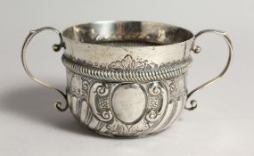 A QUEEN ANNE TWO HANDLED CIRCULAR PORRINGER, wrythen fluted handles, London 1709, maker J. JACKSON