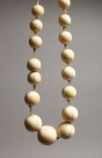 A GOOD GRADUATED IVORY BEAD NECKLACE on thirty beads 18ins long