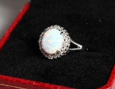 AN OPAL AND DIAMOND CLUSTER RING