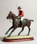 BORDER FINE ARTS. A model of a polo player on a bay horse, model.no. B0875, mounted on a wooden