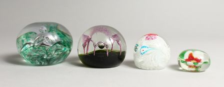FOUR GLASS PAPERWEIGHTS, A PANSY PAPERWEIGHT,A LACE WEIGHT and two others (4)