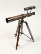 A BRASS TABLE TOP TELESCOPE ON A STAND 10ins high.