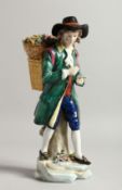A SAMSON CHELSEA DERBY PORCELAIN FIGURE of a man, a basket of flowers on his back 9ins high.