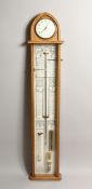 COMMITTI, LONDON, AN ADMIRAL FITZROY BAROMETER, 20TH CENTURY, the light oak case with arch top,