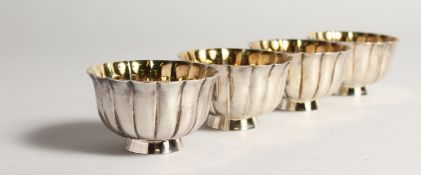 A SET OF FOUR BULGARI SILVER AND SILVER GILT SALTS in original box